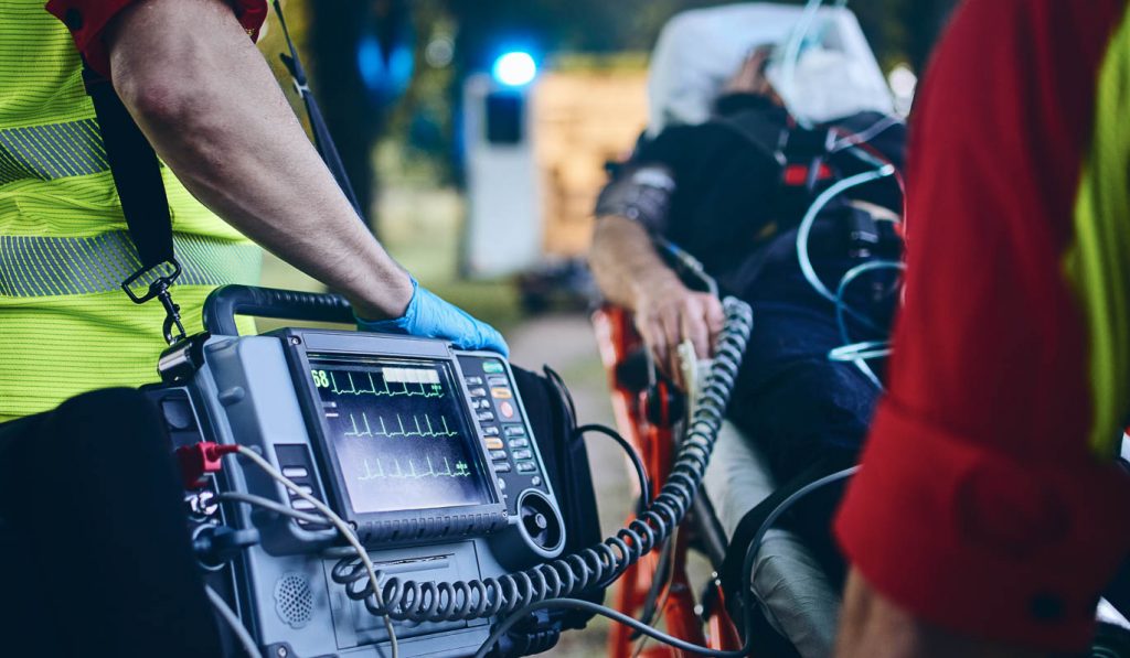 image of paramedics with health monitor hooked to patient